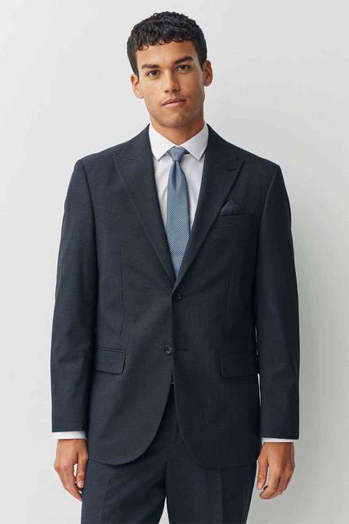 Navy men's suit with notch lapels, two-button jacket front, and matching trousers