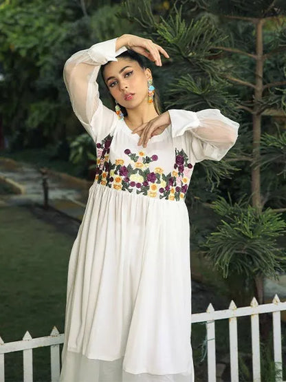 Nazmina dress in white with floral bodice and puffed sheer sleeves, hand pose