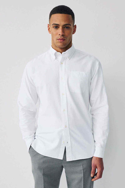 Men's white button-up shirt with long sleeves and front buttons