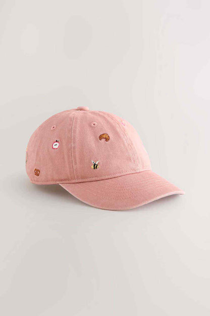 Pink baseball cap with embroidered colorful animal patches and curved brim