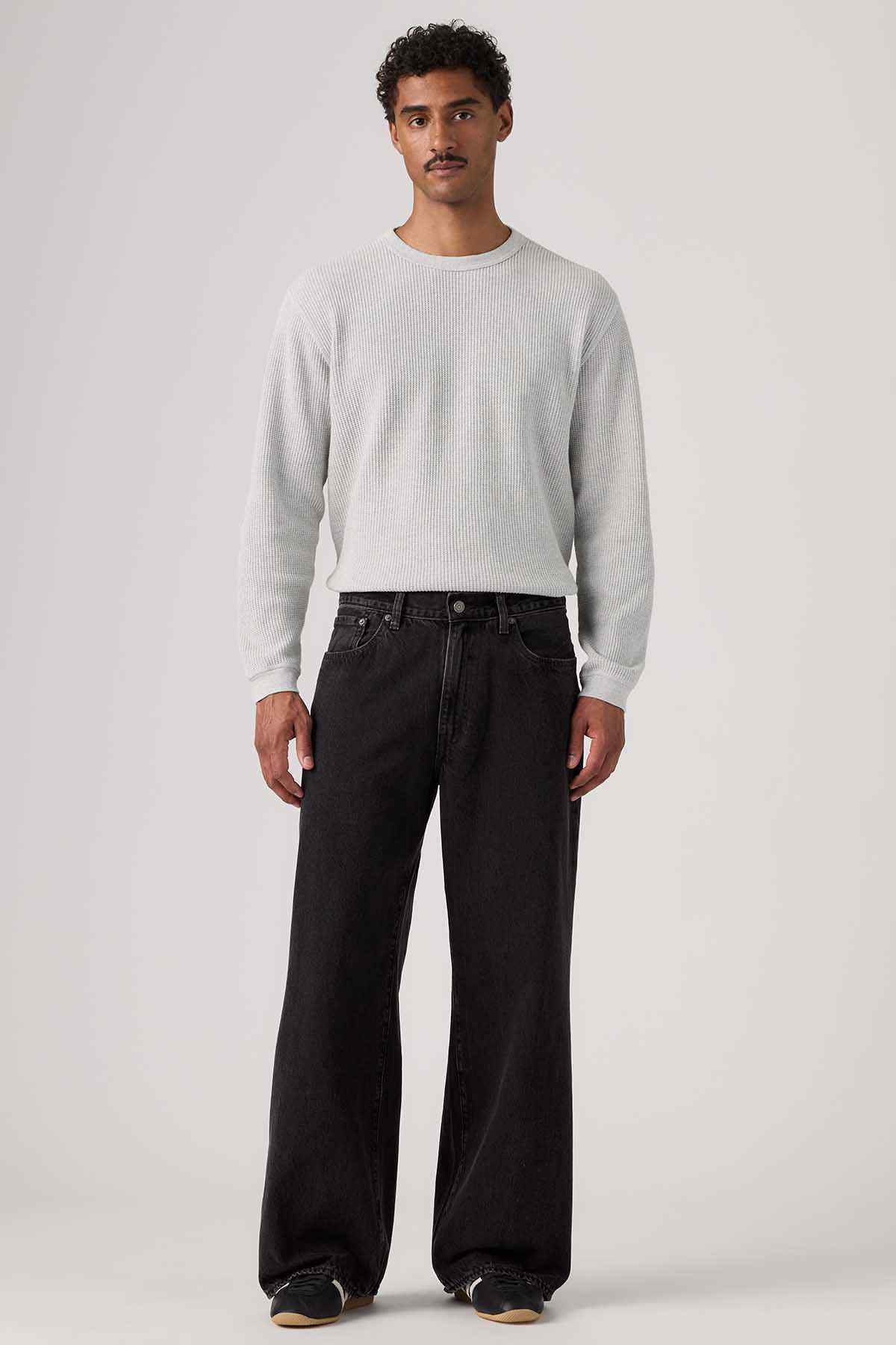 Black denim wide-leg jeans with button fly and front pockets