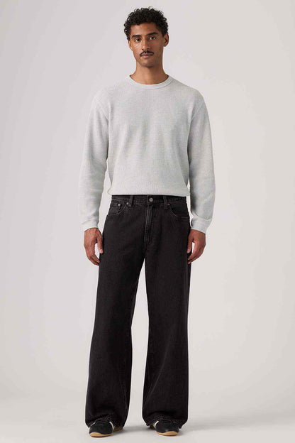 Black denim wide-leg jeans with button fly and front pockets