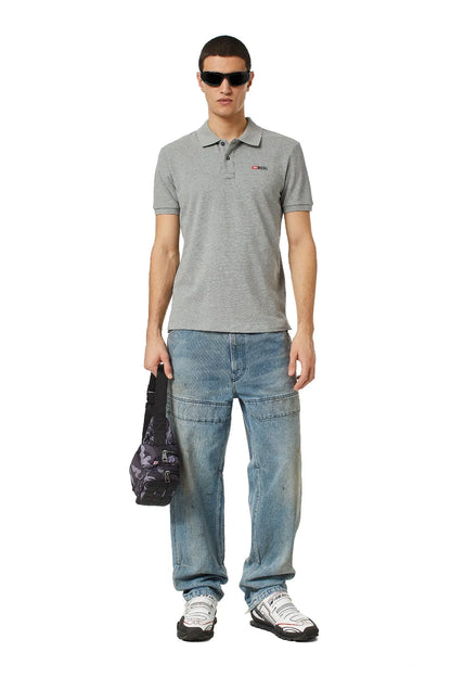 Light grey polo shirt on model with short sleeves and chest logo