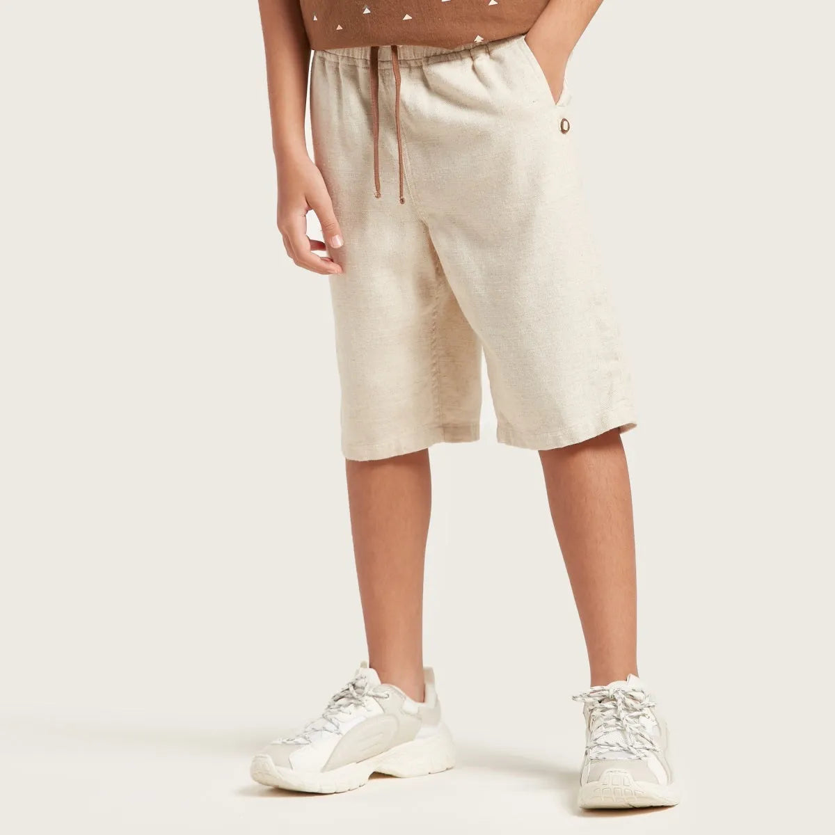Light beige kids drawstring shorts with elastic waist and side pockets