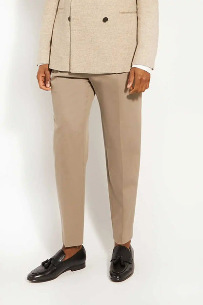 Black loafers with tassel detail, worn with tailored trousers
