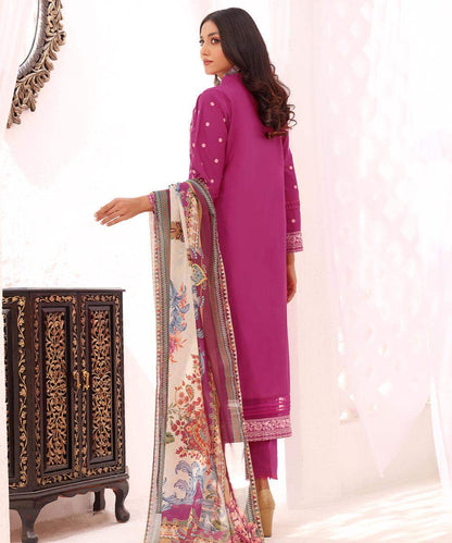 Shocking pink kurta with embroidered trim, side view holding a floral dupatta