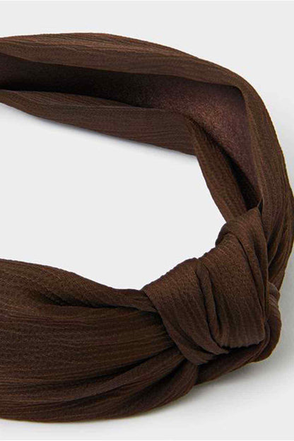 Dark brown twisted headband detail, knotted fabric loop
