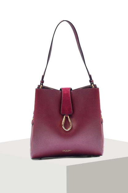 Berry leather tote bag with top handles, center strap, and gold clasp ring