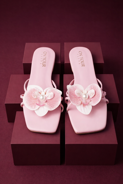 Light pink square-toe slide sandals with pink flower appliques and pearl centers