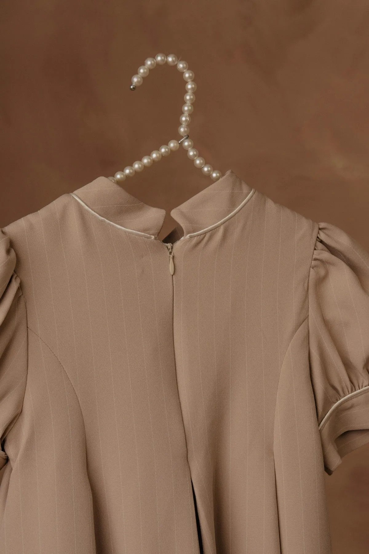 Stone dress neckline detail with stand collar and front placket