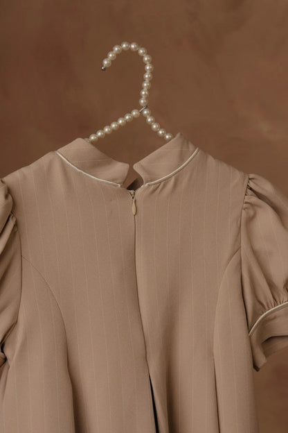 Stone dress neckline detail with stand collar and front placket