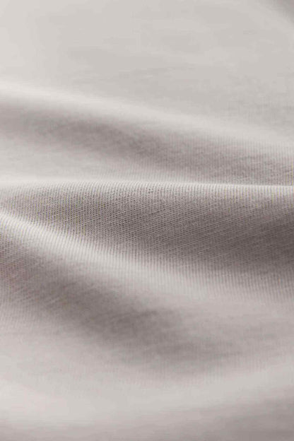 Light gray T-shirt fabric close-up showing smooth knit texture