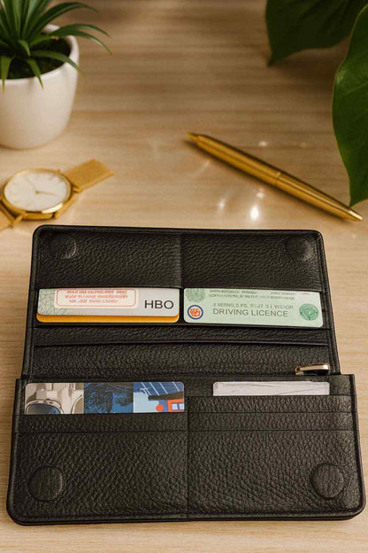 Black leather wallet open, showing ID window, card slots, and bill compartments.