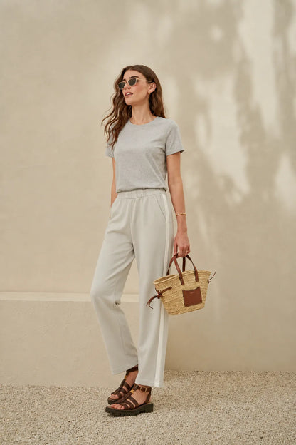 Grey crew-neck short-sleeve t-shirt and white drawstring pants, full outfit view