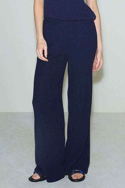 Navy wide-leg trousers with long straight legs and elastic waistband