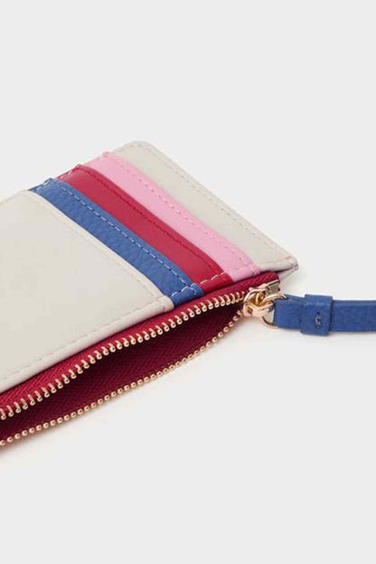 Close-up of mini clutch zip with layered pink, red, blue, and cream panels