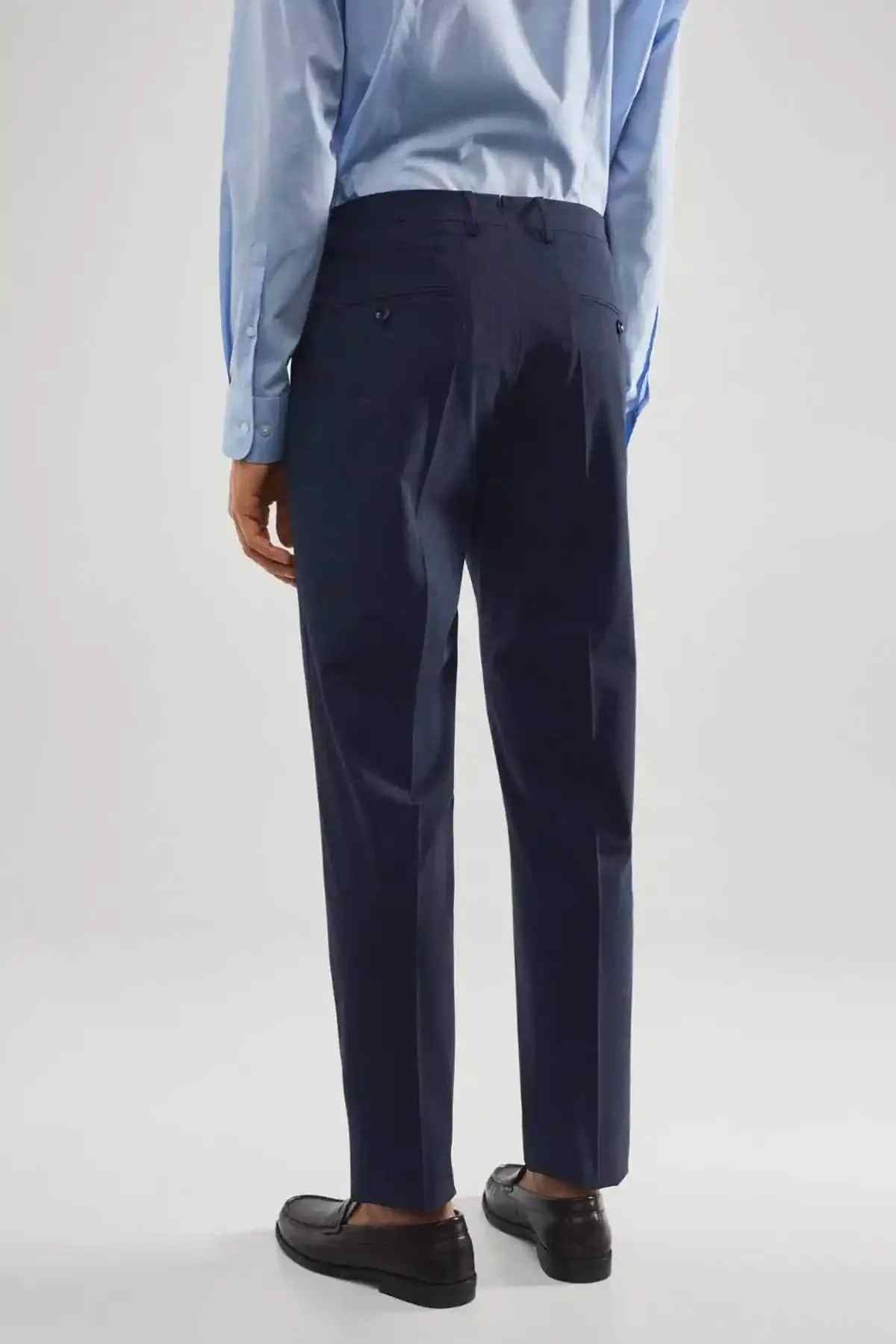 Men's indigo blue dress trousers, front view with crease and cuffless hem