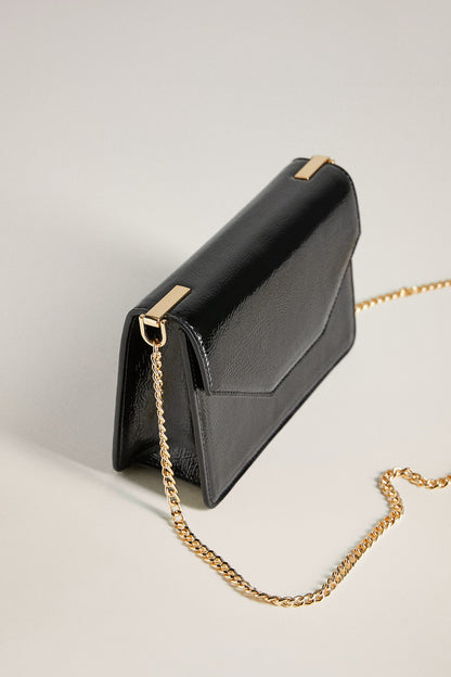 Black leather crossbody bag, structured silhouette, gold chain strap