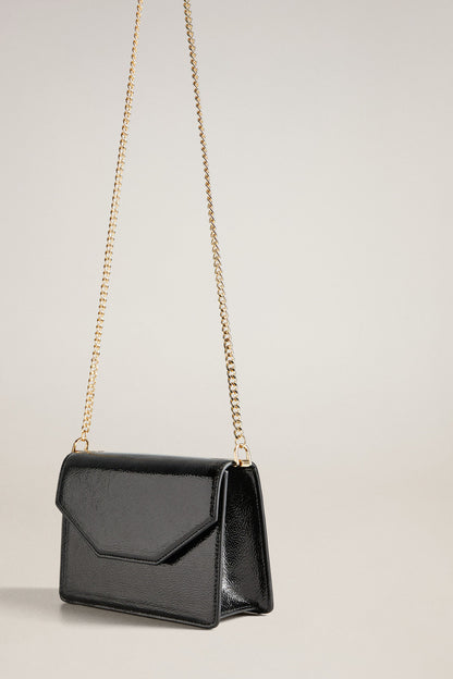Black mini crossbody bag with top flap and long gold chain