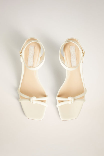 Pair of ice grey heeled sandals with bow ankle straps and open square toe