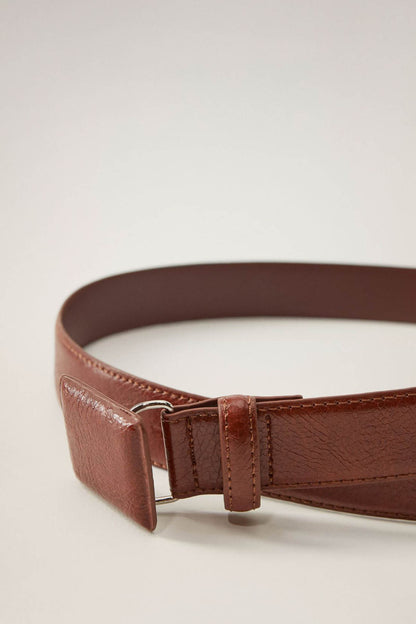 Brown leather belt detail with metal buckle and keeper strap
