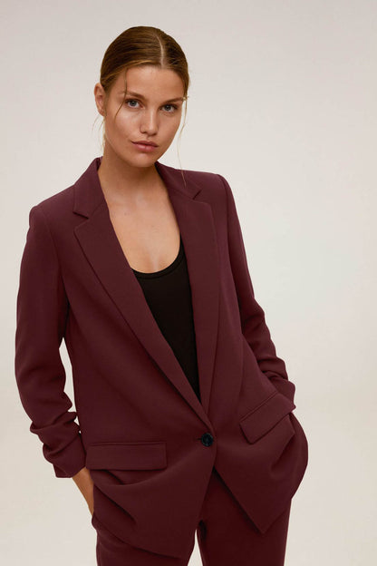 Maroon women's blazer with notched lapels and matching trousers, front view