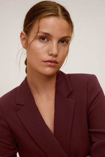 Maroon blazer close-up showing V neckline and structured lapels