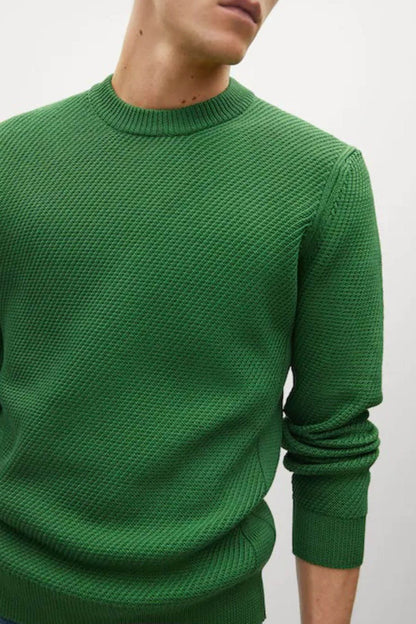 Green knit crewneck sweater close-up of ribbed collar and sleeve cuffs