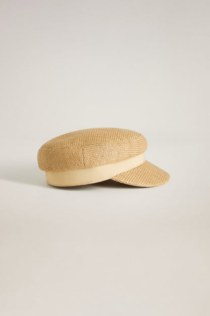 Sand straw-textured flat cap with short brim and stitched crown