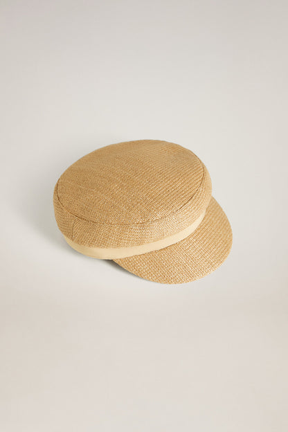 Sand straw-textured flat cap with short brim, side view