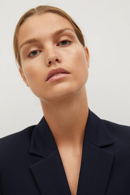 Women's dark navy blazer lapel and collar detail with a clean neckline