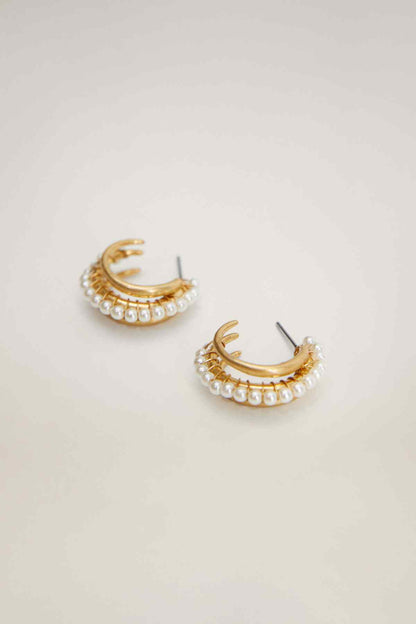 Gold half-hoop earrings with pearl bead trim and clasp posts