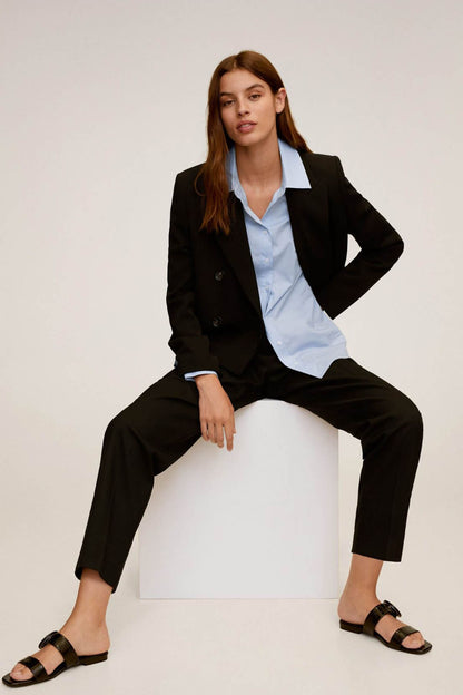 Sky blue button-up shirt worn under a black blazer, open collar