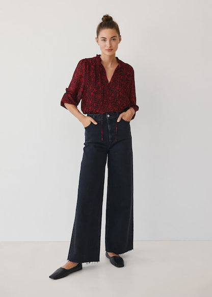Red and dark patterned button-up blouse with collar and long sleeves