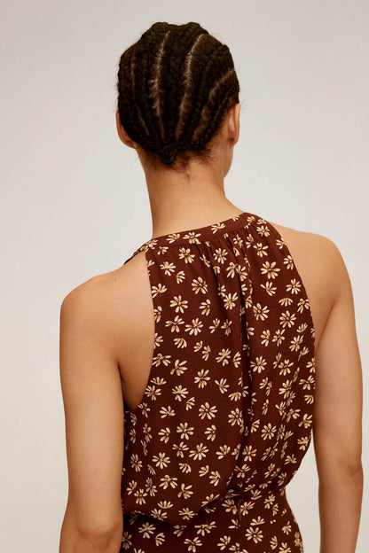 Brown floral sleeveless halter dress viewed from back with draped panel