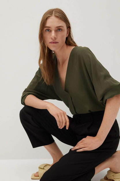 Khaki V-neck blouse with loose dolman sleeves