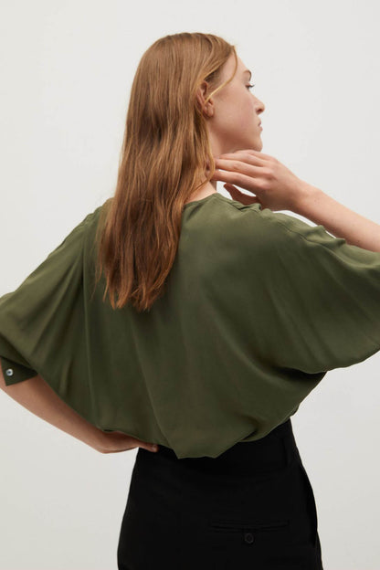 Khaki V-neck blouse with wide draped sleeves and side movement