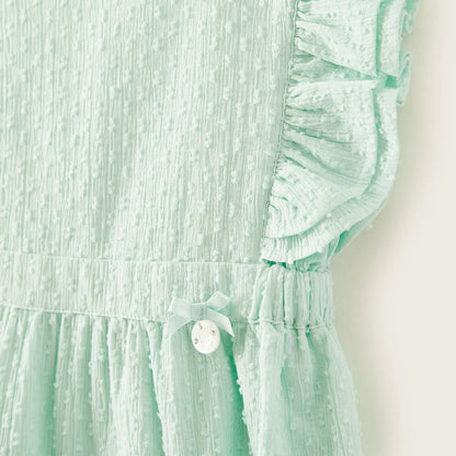 Mint green baby dress close-up: ruffled sleeve, pleated bodice, and round front button