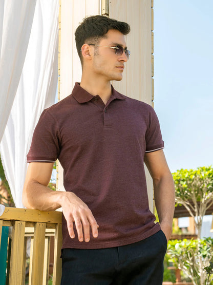 Maroon polo shirt with short sleeves and three-button placket, side view on model