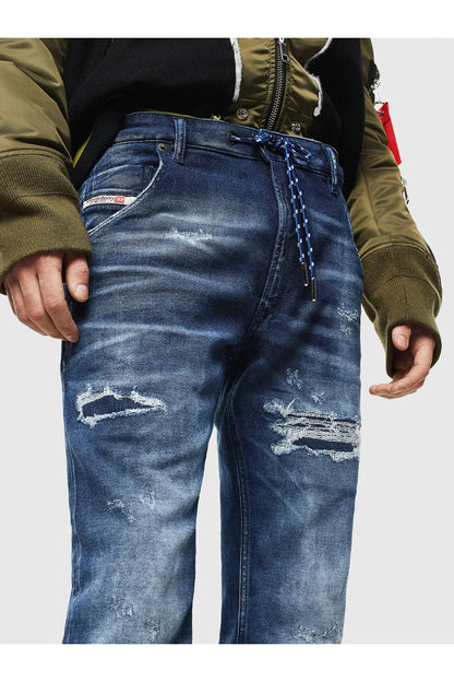 Indigo jeans front close-up with whiskering, ripped knee patches, and belt loops