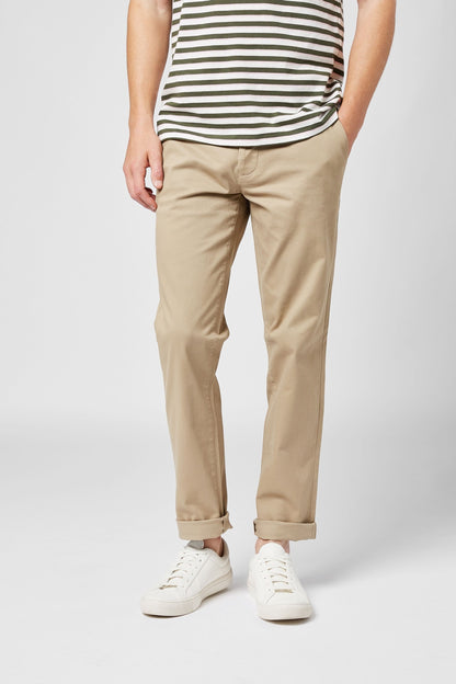 NEXT natural chino trousers on model, tapered legs, button waistband, cuffed hems