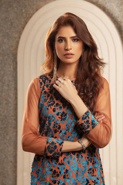 Velour tunic close-up with blue floral print and rose-gold sleeves, round neckline detail