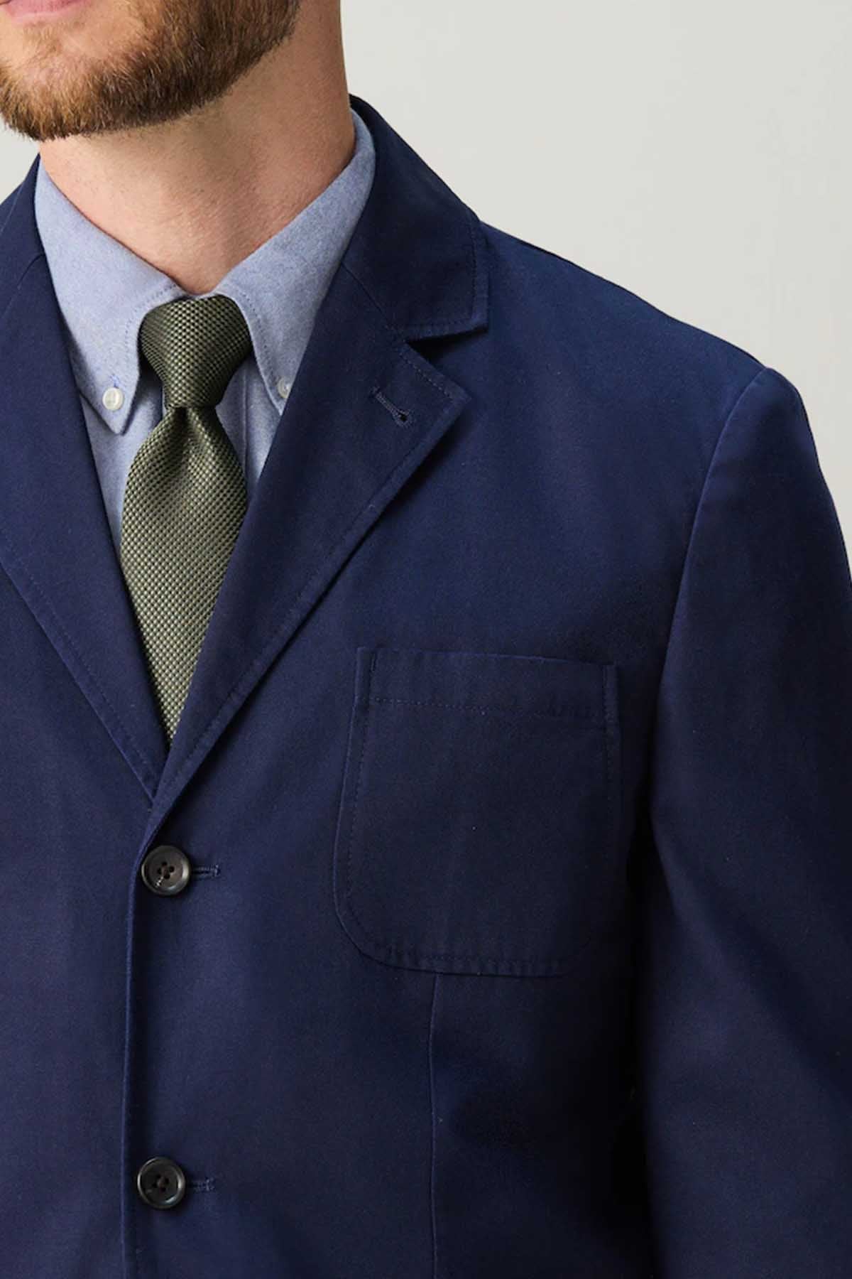 Navy men's suit jacket chest pocket and buttoned front