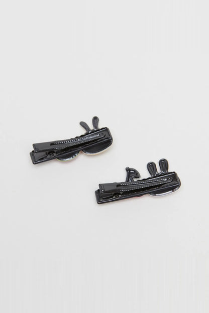 Black cartoon hair clips with animal face details on two snap clips