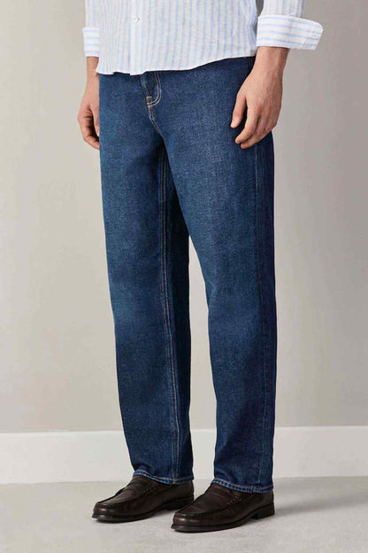 Dark blue denim jeans, full front legs with stitched seams