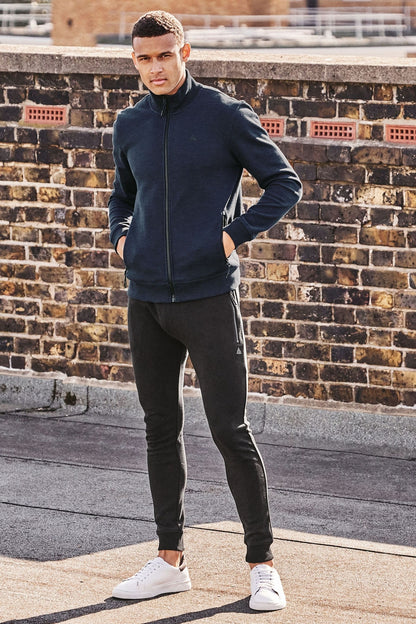 Navy zip-up sweatshirt with full front zipper, stand collar, and side pockets