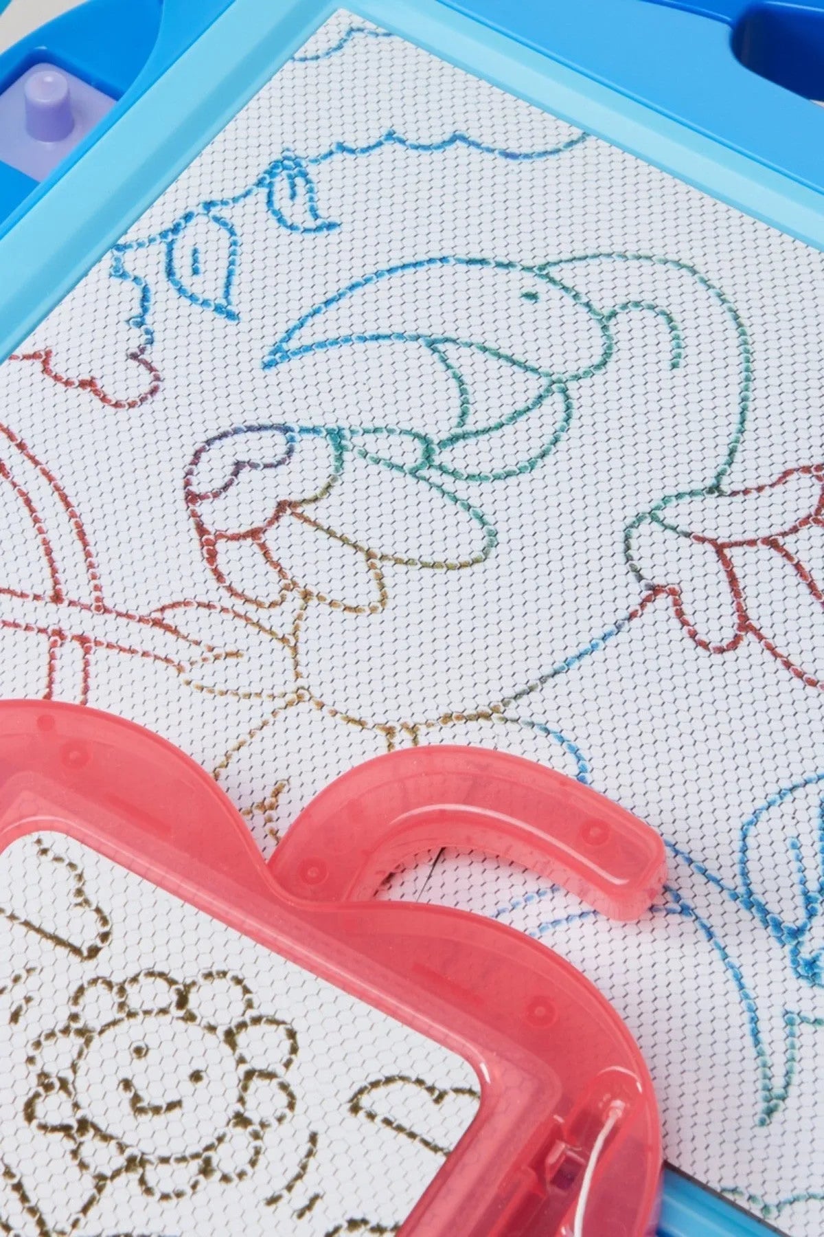 Close-up of blue drawing screen with stitched animal lines and pink plastic stamp