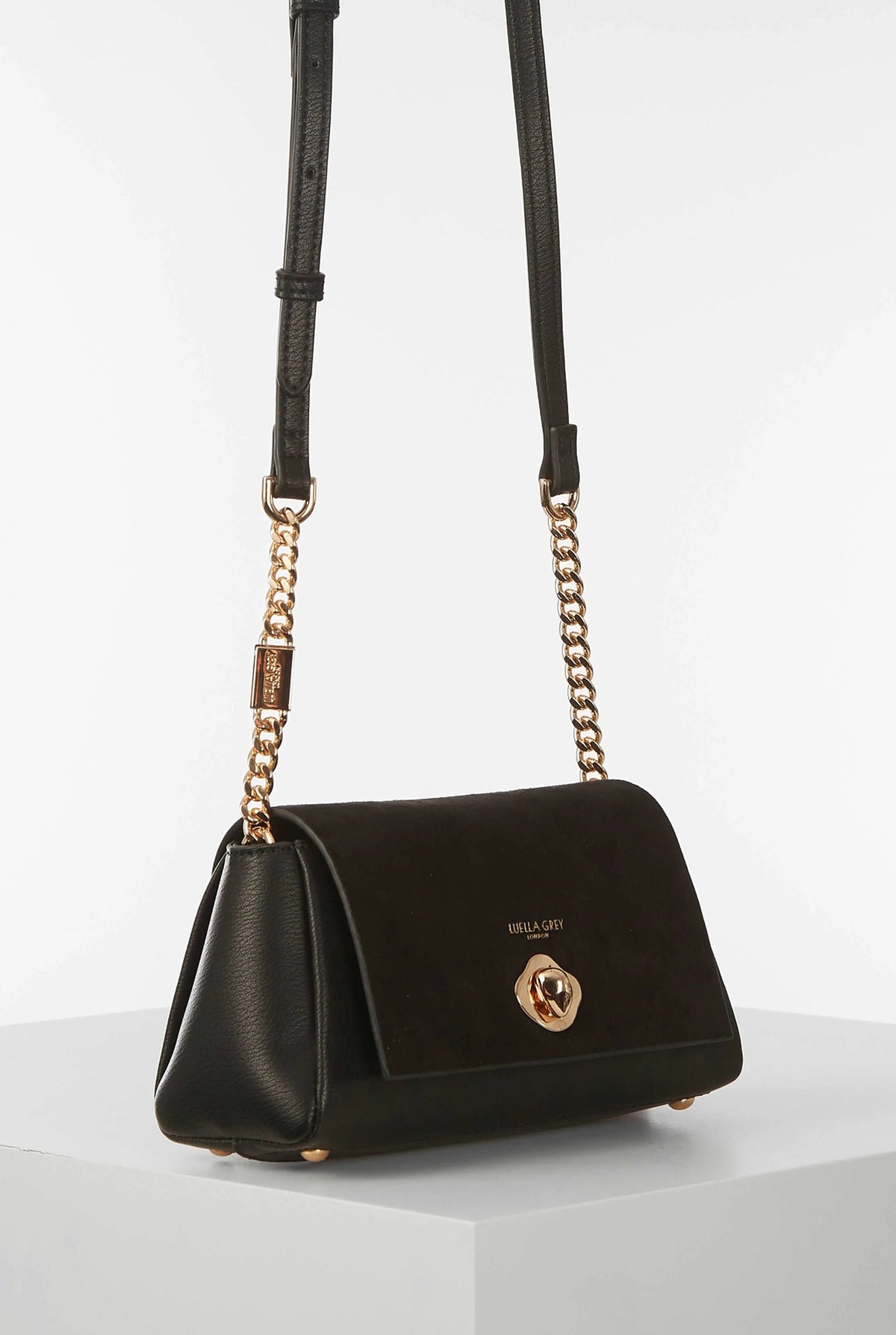 Black Luella Grey shoulder bag with chain handles, top flap, and gold emblem
