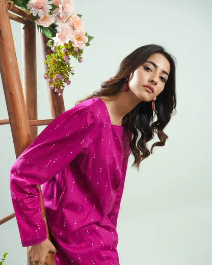 Magenta long-sleeve tunic with allover dotted print, close-up angled pose