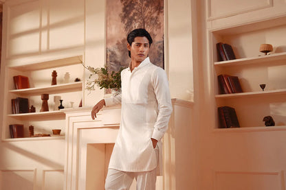 Men's white kurta and pants set, three-quarter view with one hand resting